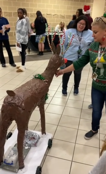Completed candy-dispensing deer mounted on its wheeled robot chassis during a classroom activity